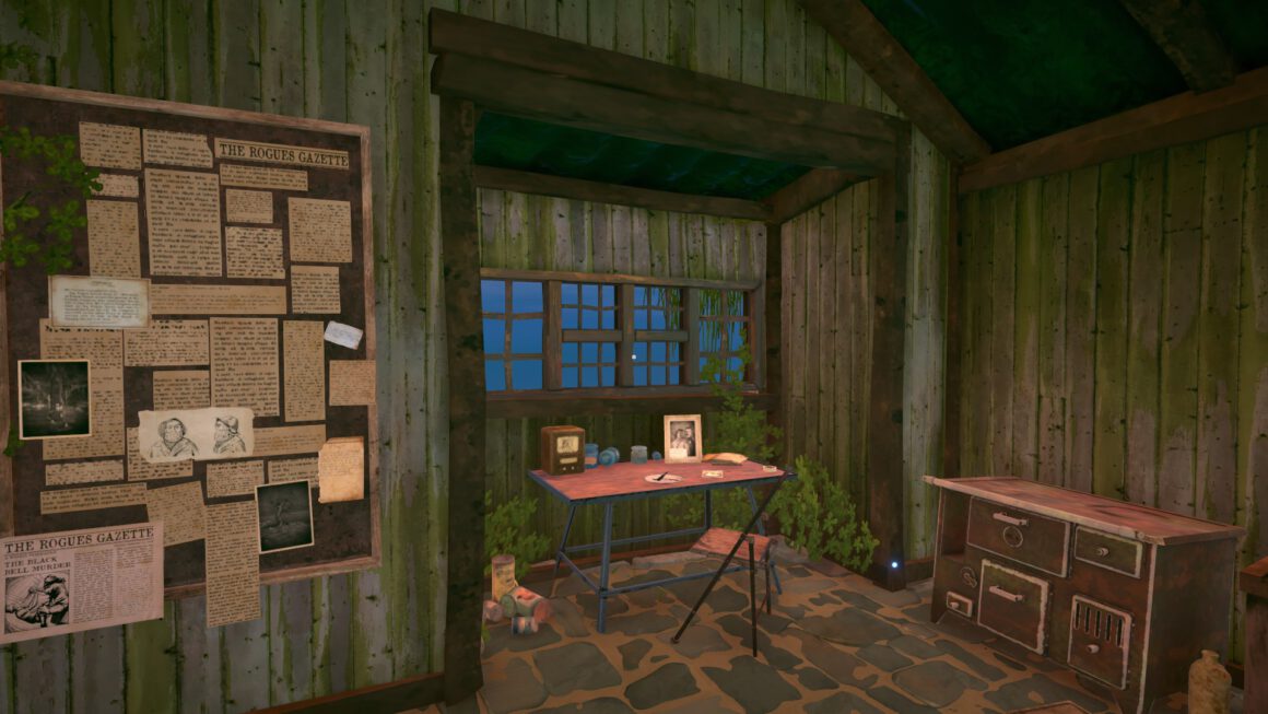 Ein wunderschöner wenn auch etwas verfallener Holzerker. In ihm steht ein einfacher Holzschreibtisch mit diversen Gegenständen wie Fotos und einem Radio. Davor steht ein Stuhl. Im Raum selbst ist ein großer alter Ofen und auf der linken Seite eine riesige Pinwannd voller alter Zeitungsausschnitte und Bilder.